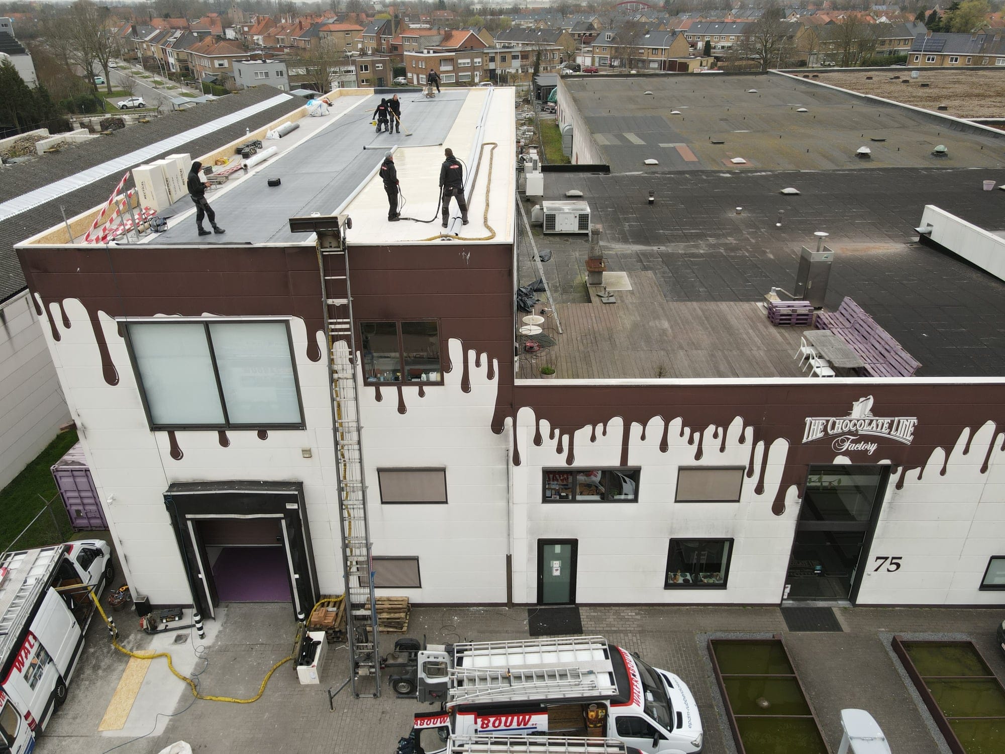 Dronebeeld van een dakrenovatieproject met nieuw aangebrachte EPDM-bedekking en kiezelafwerking